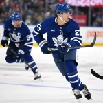 Sep 19, 2026; Toronto, Ontario, CAN; Toronto Maple Leafs forward Matthew Knies (23) looks for a pass as he leads forward Auston Matthews (34) up ice against the Montreal Canadiens in the third period at Scotiabank Arena.
