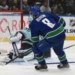 Sep 26, 2026; Vancouver, British Columbia, CAN; Vancouver Canucks defenseman Zeev Buium (8) scores a goal on Seattle Kraken goaltender Joey Daccord (35) the third period at Rogers Arena.
