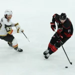 Jun 11, 2026; Raleigh, North Carolina, USA; Carolina Hurricanes defenseman Alexander Nikishin (21) carries the puck against Vegas Golden Knights right wing Mitch Marner (93) during the second period in game five of the 2026 Stanley Cup Final at Lenovo Center.