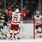 Mar 11, 2023; Boston, Massachusetts, USA; Detroit Red Wings right wing Alex Chiasson (48) celebrates his shorthanded goal with center Dylan Larkin (71) as Boston Bruins defenseman Charlie McAvoy (73) looks on during the second period at TD Garden. Mandatory Credit: Winslow Townson-USA TODAY Sports