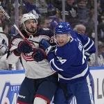 Feb 11, 2023; Toronto, Ontario, CAN; Toronto Maple Leafs defenseman Morgan Rielly (44) and Columbus Blue Jackets forward Kirill Marchenko (86) battle along the boards during the second period at Scotiabank Arena.