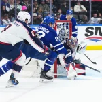 Apr 5, 2025; Toronto, Ontario, CAN; Toronto Maple Leafs right wing William Nylander (88) battles for the puck with Columbus Blue Jackets defenseman Zach Werenski (8) in front of goaltender Elvis Merzlikins (90) during the first period at Scotiabank Arena.