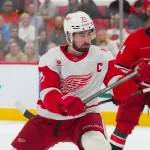 Feb 28, 2026; Raleigh, North Carolina, USA; Detroit Red Wings center Dylan Larkin (71) takes a shot against the Carolina Hurricanes during the second period at Lenovo Center.