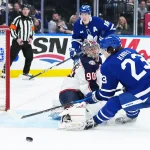 Apr 5, 2025; Toronto, Ontario, CAN; Toronto Maple Leafs left wing Matthew Knies (23) battles for the puck with Columbus Blue Jackets goaltender Elvis Merzlikins (90) during the third period at Scotiabank Arena.