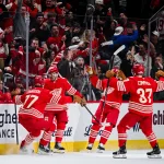 Mar 19, 2026; Detroit, Michigan, USA; Detroit Red Wings right wing Alex DeBrincat (93) celebrates with defenseman Simon Edvinsson (77) and left wing J.T. Compher (37) after scoring a goal during the third period against the Montreal Canadiens at Little Caesars Arena.