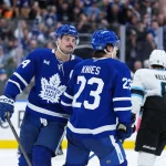 Nov 5, 2025; Toronto, Ontario, CAN; Toronto Maple Leafs left wing Matthew Knies (23) scores an empty net goal and celebrates with center Auston Matthews (34) against the Utah Mammoth during the third period at Scotiabank Arena.