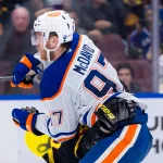 Jan 18, 2025; Vancouver, British Columbia, CAN; Edmonton Oilers forward Connor McDavid (97) battles with Vancouver Canucks forward Conor Garland (8) in the third period at Rogers Arena.
