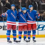Apr 5, 2026; New York, New York, USA; New York Rangers left wing Conor Sheary (43) celebrates his goal against the Washington Capitals with defenseman Vladislav Gavrikov (44) and left wing Tye Kartye (24) during the first period at Madison Square Garden.