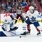 Sep 19, 2026; Montreal, Quebec, CAN; Toronto Maple Leafs defenseman Cole McWard (82) defends as goalie Samuel Hlavaj (31) makes a save against Montreal Canadiens left wing Lucas Condotta (82) during the second period at Bell Centre.
