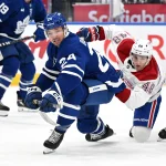 Sep 29, 2026; Toronto, Ontario, CAN; Toronto Maple leafs forward Brandon Duhaime (24) collides with Montreal Canadiens defenseman Late Hutson (48) in the first period at Scotiabank Arena.