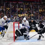 Apr 4, 2026; Los Angeles, California, USA; Los Angeles Kings right wing Joel Armia (40) and left wing Trevor Moore (12) help goaltender Darcy Kuemper (35) defend the goal against Toronto Maple Leafs center Max Domi (11) and center Dakota Joshua (81) during the third period at Crypto.com Arena.