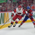 May 25, 2026; Montreal, Quebec, CAN; Carolina Hurricanes defenseman Alexander Nikishin (21) skates against Montreal Canadiens center Alex Newhook (15) during the third period in game three of the Eastern Conference Final of the 2026 Stanley Cup Playoffs at Bell Centre