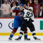 Sep 30, 2026; Denver, Colorado, USA; Colorado Avalanche center Nathan MacKinnon (29) and Los Angeles Kings defenseman Brandt Clarke (92) fight in the third period at Ball Aren