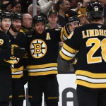 Dec 18, 2025; Boston, Massachusetts, USA; Boston Bruins center Pavel Zacha (18) (second from left) celebrates his goal with center Morgan Geekie (39) and right wing David Pastrnak (88) during the first period against the Edmonton Oilers at TD Garden.