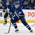 Sep 30, 2026; Toronto, Ontario, CAN; Toronto Maple Leafs forward Auston Matthews (34) retrieves the puck against the New York Islanders in the second period at Scotiabank Arena.