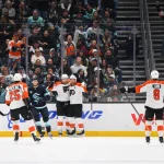 Oct 17, 2024; Seattle, Washington, USA; The Philadelphia Flyers celebrate after a goal scored by center Scott Laughton (21) during the first period against the Seattle Kraken at Climate Pledge Arena. Mandatory Credit: Steven Bisig-Imagn Images