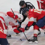 Jan 16, 2025; Sunrise, Florida, USA; Detroit Red Wings center Dylan Larkin (71) and Florida Panthers center Aleksander Barkov (16) face-off during the third period at Amerant Bank Arena.