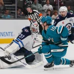 Nov 7, 2025; San Jose, California, USA; Winnipeg Jets goalie Connor Hellebuyck (37) makes a save and defenseman Dylan DeMelo (2) watches the play against San Jose Sharks center Ty Dellandrea (10) during the second period at SAP Center at San Jose.