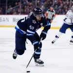 Mar 5, 2026; Winnipeg, Manitoba, CAN; Winnipeg Jets forward Mark Scheifele (55) skates into the Tampa Bay Lightning zone during the second period at Canada Life Centre.