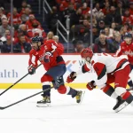 Dec 11, 2025; Washington, District of Columbia, USA; Washington Capitals left wing Alex Ovechkin (8) shoots the puck as Carolina Hurricanes defenseman Alexander Nikishin (21) defends during the third period at Capital One Arena.