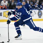 Sep 30, 2026; Toronto, Ontario, CAN; Toronto Maple Leafs forward Easton Cowan (53) steps into a shot against the New York Islanders in the first period at Scotiabank Arena.