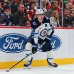 Jan 31, 2026; Sunrise, Florida, USA; Winnipeg Jets center Mark Scheifele (55) moves the puck against the Florida Panthers during the first period at Amerant Bank Arena.