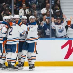 Oct 1, 2026; Vancouver, British Columbia, CAN; Edmonton Oilers defenseman Evan Bouchard (2) and forwards Connor McDavid (97) and Vasily Podkolzin (92) and Leon Draisaitl (29) celebrate Draisaitl's goal against the Vancouver Canucks in the third period at Rogers Arena.