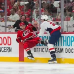 Oct 2, 2026; Raleigh, North Carolina, USA; Washington Capitals defenseman Matt Roy (3) checks Carolina Hurricanes left wing Taylor Hall (71) during the first period at Lenovo Center.