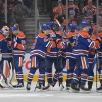 Oct 3, 2026; Edmonton, Alberta, CAN; Edmonton Oilers goalie Devon Levi (27) and center Leon Draisaitl (29) celebrate their win over the Seattle Kraken during the third period at Rogers Place.