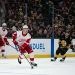 Jan 13, 2026; Boston, Massachusetts, USA; Detroit Red Wings defenseman Simon Edvinsson (77) skates with the puck during the third period of the game against the Boston Bruins at TD Garden.