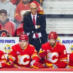 Oct 1, 2026; Calgary, Alberta, CAN; Calgary Flames head coach Ryan Huska on his bench during the first period against the Seattle Kraken at Scotiabank Saddledome. :