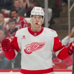 Feb 28, 2026; Raleigh, North Carolina, USA; Detroit Red Wings defenseman Simon Edvinsson (77) celebrates his goal against the Carolina Hurricanes during the second period at Lenovo Center.