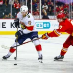 Mar 20, 2026; Calgary, Alberta, CAN; Florida Panthers center Sam Bennett (9) and Calgary Flames center Connor Zary (47) battle for the puck during the third period at Scotiabank Saddledome.