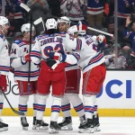 Jan 19, 2026; Anaheim, California, USA; New York Rangers defenseman Matthew Robertson (second from right) celebrates with Will Borgen (17) and Gabe Perreault (94) and Mika Zibanejad (93) and J.T. Miller (8) after scoring a goal during the first period against the Anaheim Ducks at Honda Center.