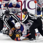 Jan 9, 2025; Pittsburgh, Pennsylvania, USA; Edmonton Oilers defenseman Darnell Nurse (25) and Pittsburgh Penguins left wing Michael Bunting (8) are separated by officials during a tussle on the ice in the third period at PPG Paints Arena.