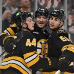 Oct 5, 2026; Boston, Massachusetts, USA; Boston Bruins center James Hagens (44) celebrates his goal against the Ottawa Senators with left wing Tanner Jeannot (84) and center Matthew Poitras (51) during the third period at TD Garden.