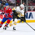 Mar 17, 2026; Montreal, Quebec, CAN; Boston Bruins center Pavel Zacha (18) plays the puck against Montreal Canadiens left wing Juraj Slafkovsky (20) during the first period at Bell Centre. Mandatory Credit: David Kirouac-Imagn Images