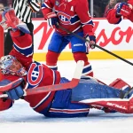 Oct 6, 2026; Montreal, Quebec, CAN; Montreal Canadiens goalie Jakub Dobes (75) makes a save against the Carolina Hurricanes during the second period at the Bell Centre.