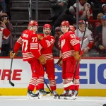 Nov 9, 2025; Detroit, Michigan, USA; Detroit Red Wings defenseman Simon Edvinsson (77) and defenseman Moritz Seider (53) celebrate a goal scored by center Dylan Larkin (71) during the first period at Little Caesars Arena.