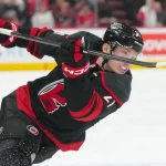 Apr 7, 2026; Raleigh, North Carolina, USA; Carolina Hurricanes defenseman Alexander Nikishin (21) takes a shot aBoston Bruins during the third period at Lenovo Center.