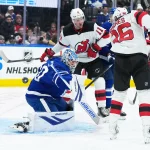 Dec 30, 2025; Toronto, Ontario, CAN; New Jersey Devils right wing Stefan Noesen (11) battles for the puck in front of Toronto Maple Leafs goaltender Joseph Woll (60) during the second period at Scotiabank Arena.