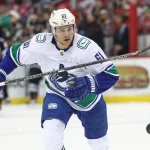 Feb 6, 2023; Newark, New Jersey, USA; Vancouver Canucks defenseman Riley Stillman (61) chases a loose puck during the first period against the New Jersey Devils at Prudential Center.
