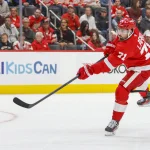Oct 6, 2026; Detroit, Michigan, USA; Detroit Red Wings center Dylan Larkin (71) shoots the puck during the second period against the Ottawa Senators at Little Caesars Arena.