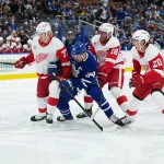 Oct 2, 2025; Toronto, Ontario, CAN; Toronto Maple Leafs center Auston Matthews (34) battles with Detroit Red Wings defenseman Simon Edvinsson (77) during the first period at Scotiabank Arena.