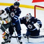 Jan 6, 2026; Winnipeg, Manitoba, CAN; Vegas Golden Knights forward Brandon Saad( 20) jostles for position with Winnipeg Jets defenseman Josh Morrissey (44) in front of Winnipeg Jets goalie Connor Hellebuyck (37) during the third period at Canada Life Centre.