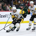 Oct 30, 2025; Saint Paul, Minnesota, USA; Pittsburgh Penguins defenseman Mathew Dumba (24) skates with the puck as Minnesota Wild left wing Marcus Johansson (90) defends during the second period at Grand Casino Arena.
