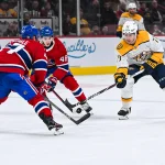 5 décembre 2024 ; Montréal, Québec, Canada ; l'ailier droit des Predators de Nashville, Luke Evangelista (77), dispute la rondelle au défenseur des Canadiens de Montréal, Jayden Struble (47), durant la troisième période au Centre Bell.