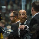 Oct 3, 2026; Vancouver, British Columbia, CAN; Vancouver Canucks head coach Manny Malhotra on the bench against the Calgary Flames in the second period at Rogers Arena.