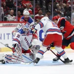 Oct 9, 2026; Washington, District of Columbia, USA; New York Rangers goaltender Igor Shesterkin (31) makes a save on Washington Capitals right wing Ryan Leonard (9) during the first period at Capital One Arena.