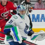 Oct 8, 2026; Raleigh, North Carolina, USA; Vancouver Canucks goaltender Leevi Merilainen (31) watches the shot against the Carolina Hurricanes during the third period at Lenovo Center.